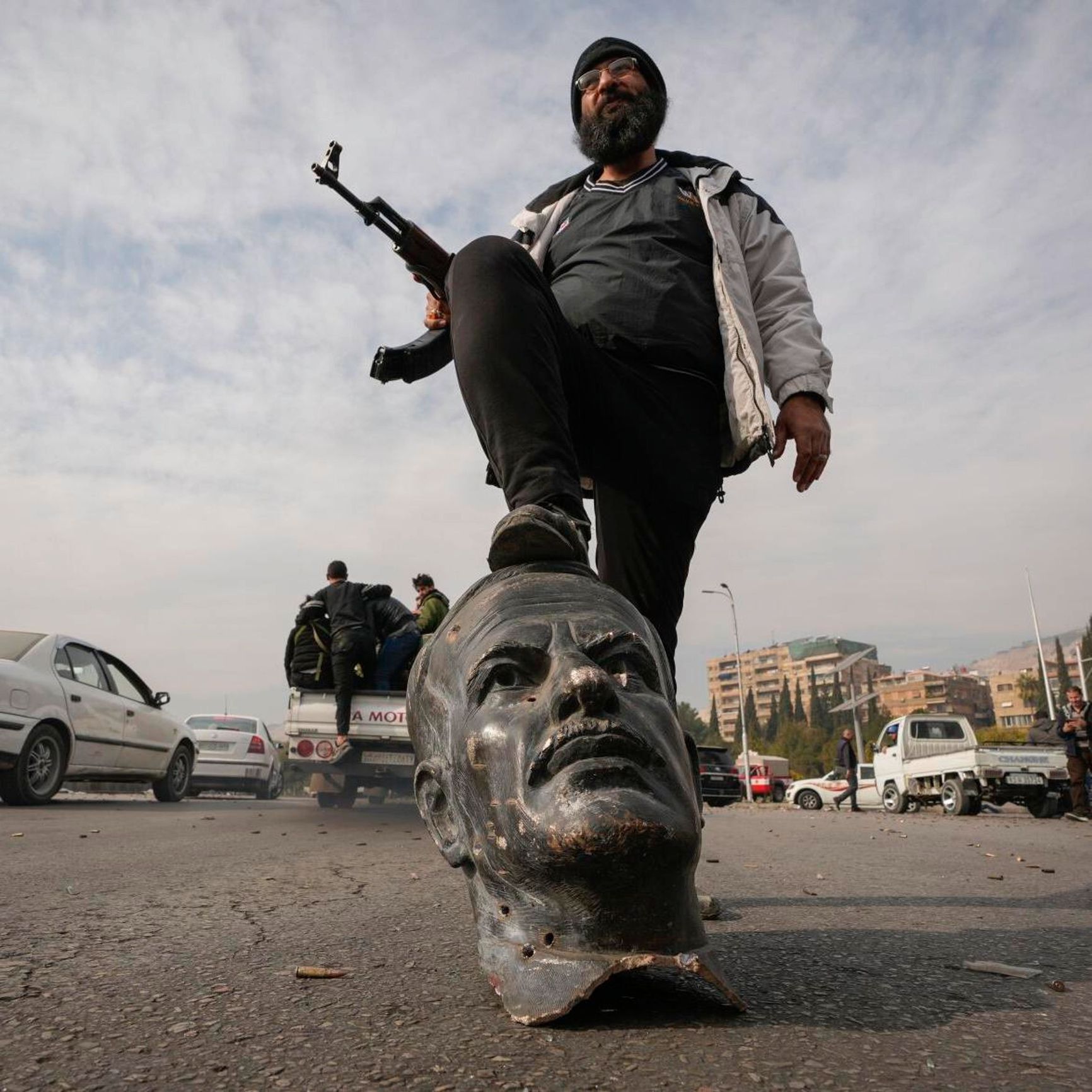 The head of a toppled statue of Hafez al-Assad